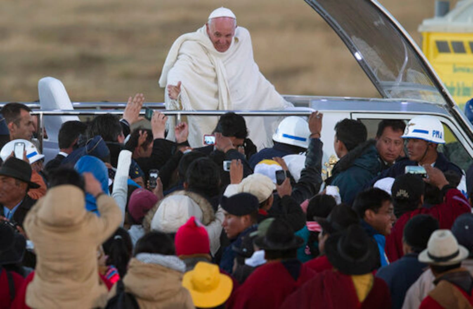 FILE - Pope Francis waves from the popemobile after arriving to El Alto International airport in El Alto, Bolivia, Wednesday, July 8, 2015. (AP Photo/Eduardo Verdugo, file)