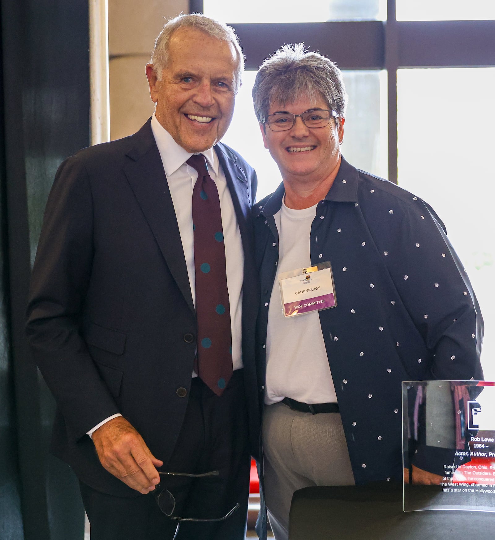 Charles "Chuck" Lowe poses with Wright Dunbar Walk of Fame committee member Cathi Spaugy after Lowe represented his son Rob during the 2025 Dayton Region Walk of Fame inductee luncheon, which was held Tuesday, Sept. 24 at Sinclair Community College. The Original Lakeside, the Levin family, Rob Lowe, Jenell Ross and Vic Cassano Sr. were inducted. BRYANT BILLING / STAFF