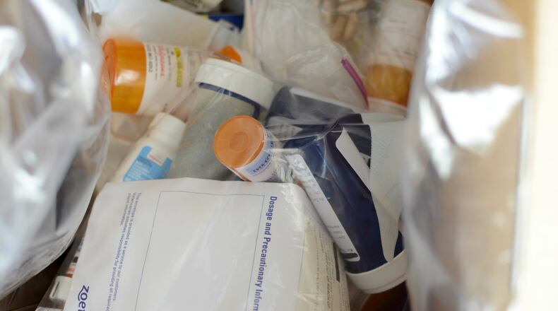 Several Butler County police agencies collected old prescription drugs Saturday including in front of the Hamilton Police Department on South Front Street. Agencies collected dozens of pounds of expired or unused prescription medication. MICHAEL D. PITMAN/STAFF