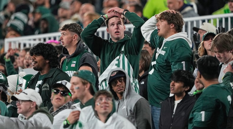 Michigan State fans react during the first half of an NCAA college football game against Michigan Saturday, Oct. 25, 2025, in East Lansing, Mich. (AP Photo/Ryan Sun)