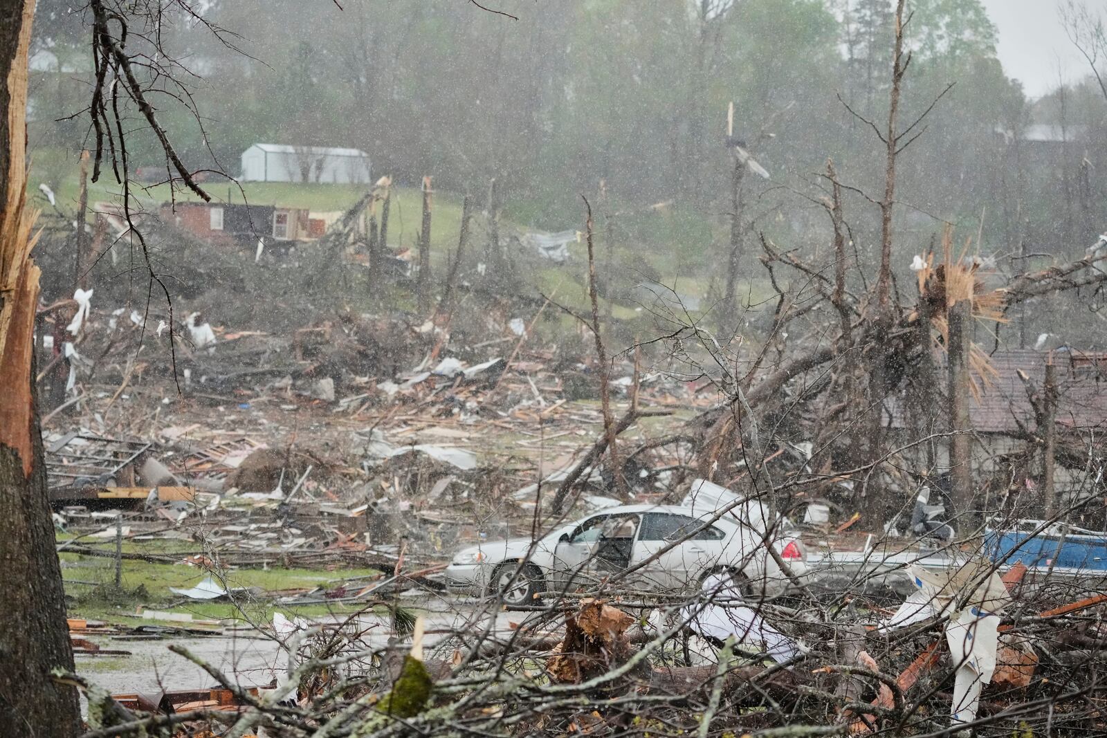 Storm damaged homes and broken trees are seen Thursday, April 3, 2025, in Selmer, Tenn. (AP Photo/George Walker IV)