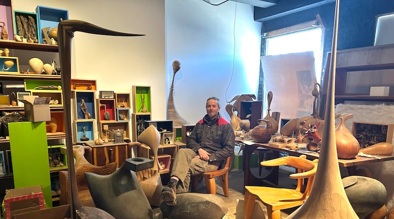 Shon Walters in his Wayne Avenue Studio, surrounded by his wood sculptures and furniture. The artist has run Eccentric Wood for 25 years.