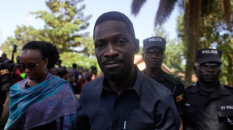 Uganda opposition presidential candidate Robert Kyagulanyi Ssentamu, famously known as Bobi Wine of the National Unity Platform (NUP), arrives with his wife to cast their votes, during the presidential election at a polling station, in Kampala, Uganda, Thursday, Jan. 15, 2026. (AP Photo/Brian Inganga)