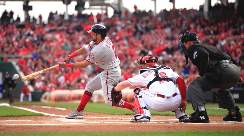The Nationals’ Adam Eaton singles against the Reds in the first at-bat of the season on Opening Day on Friday, March 30, 2018, at Great American Ball Park in Cincinnati. David Jablonski/Staff