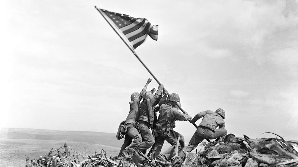 FILE - U.S. Marines of the 28th Regiment, 5th Division, raise a U.S. flag atop Mount Suribachi, Iwo Jima, Japan, Feb. 23, 1945. (AP Photo/Joe Rosenthal, File)
