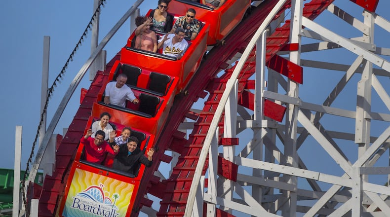 Visitors ride the Giant Dipper Roller Coaster at the Santa Cruz Beach Boardwalk in Santa Cruz, Calif., on July 3, 2016. (Patrick Tehan/Bay Area News Group/TNS)