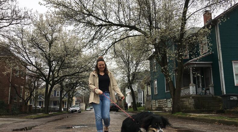 Kerrie Josefovsky walks her Australian Shepherd, Ronnie, near her South Park neighborhood home. Staff photo / Sarah Franks