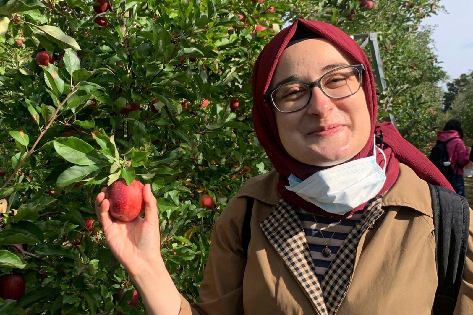 FILE- This contributed photo shows Rumeysa Ozturk on an apple-picking trip in 2021. (AP Photo)