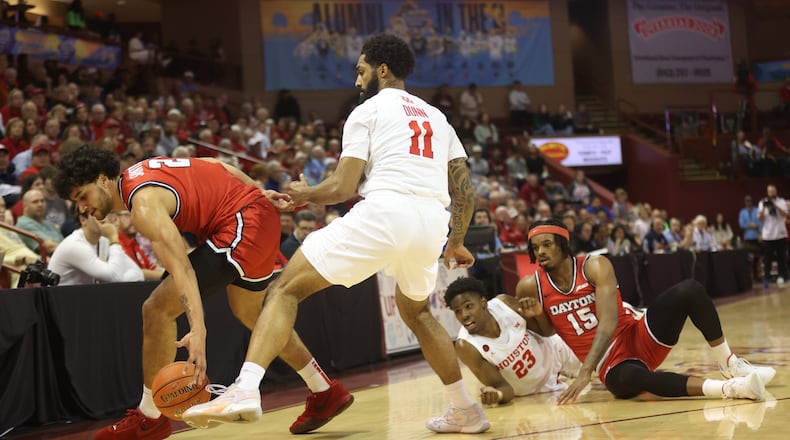 Dayton's Nate Santos, left, chases a loose ball against Houston in the Charleston Classic championship game on Sunday, Nov. 19, 2023, at TD Arena in Charleston, S.C. David Jablonski/Staff