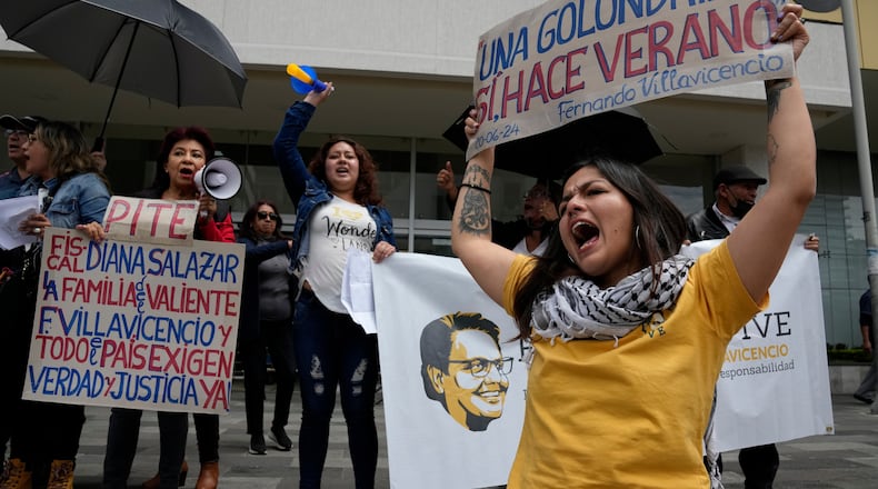 FILE - Amanda Villavicencio, the daughter of murdered presidential candidate Fernando Villavicencio, protests with other members of her family outside the court where suspects in her father's murder are being tried, in Quito, Ecuador, June 27, 2024. (AP Photo/Dolores Ochoa, File)