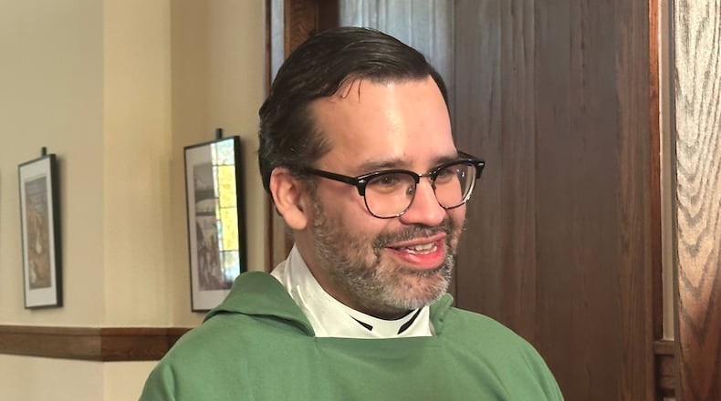 Rev. Hierald Osorto speaks to congregants after services at the St. Paul's-San Pablo Lutheran Church, in Minneapolis, Sunday, Jan. 11, 2026. (AP Photo/Rebecca Santana)