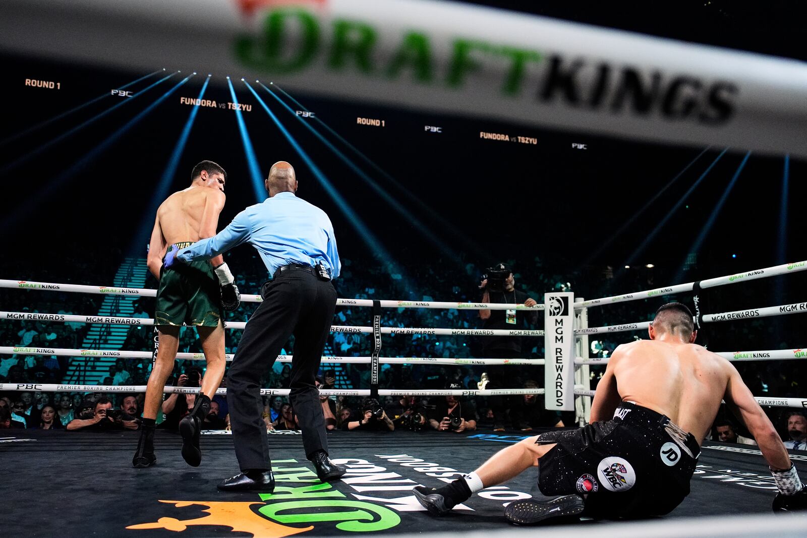 Tim Tszyu, right, reacts after being knocked down by Sebastian Fundora, left, in a super welterweight title boxing match Saturday, July 19, 2025, in Las Vegas. (AP Photo/John Locher)
