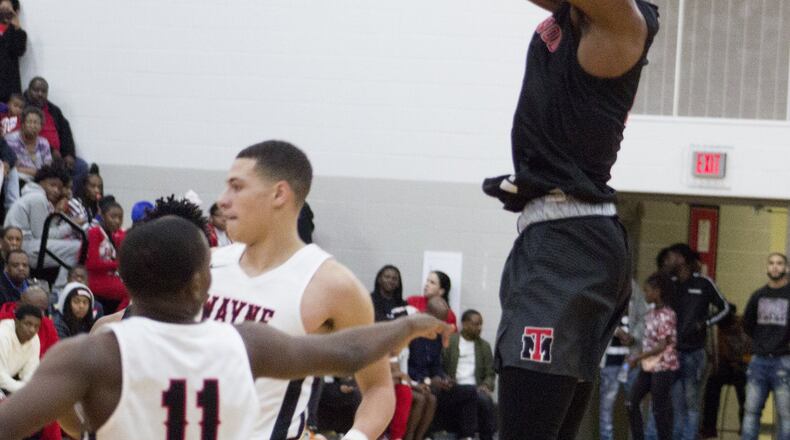 Trotwood Madison guard Amari Davis shoots over the Wayne defense in the first half Friday night at Wayne. Davis scored 43 points in the Rams’ 91-88 overtime loss. Jeff Gilbert/CONTRIBUTED