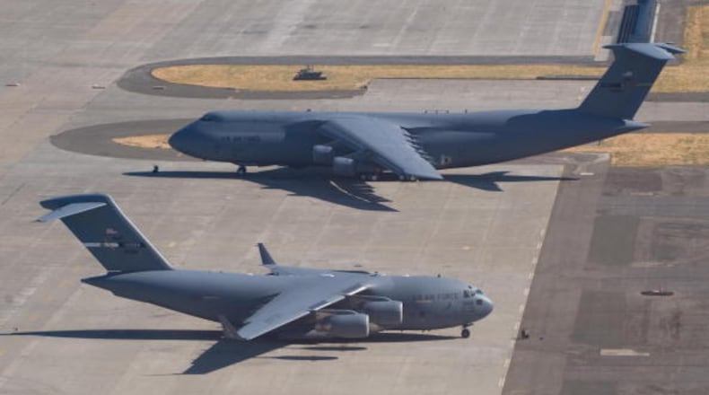 A US Air Force C-5 Galaxy and a C-17 Globemaster sit on the tarmac at Travis Air Force Base in Fairfield, California, on July 17, 2008. AFP PHOTO / SAUL LOEB (Photo credit should read SAUL LOEB/AFP/Getty Images)