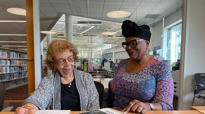 Dunbar historian and scholar LaVerne Sci (left) reflects on Paul Laurence Dunbar's legacy with Dunbar High School Alumni Association President Margaret Booze.