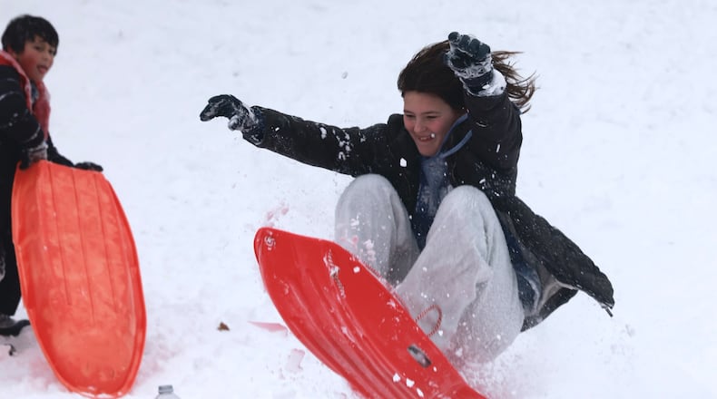 Instead of going back to school Monday, Jan. 6, 2025 a group of kids were having fun sledding at Bomberger Park in Dayton. BILL LACKEY/STAFF