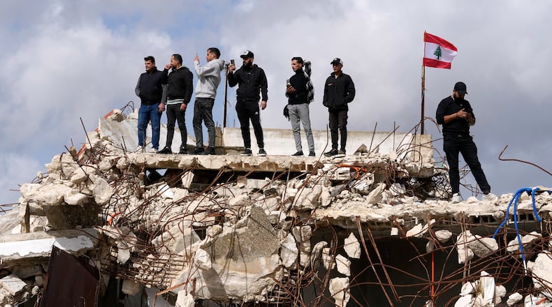 People gather as Lebanese Prime Minister Nawaf Salam tours areas in southern Lebanon along the border with Israel that the Lebanese army says it has been cleared of the armed presence of the militant Hezbollah group, in the village of Yarine, Saturday, Feb. 7, 2026. (AP Photo/Mohammed Zaatari)