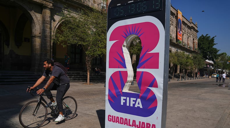 A cyclist rides past an installation promoting the FIFA World Cup 2026 in Guadalajara, Mexico, Wednesday, Feb. 25, 2026. (AP Photo/Marco Ugarte)