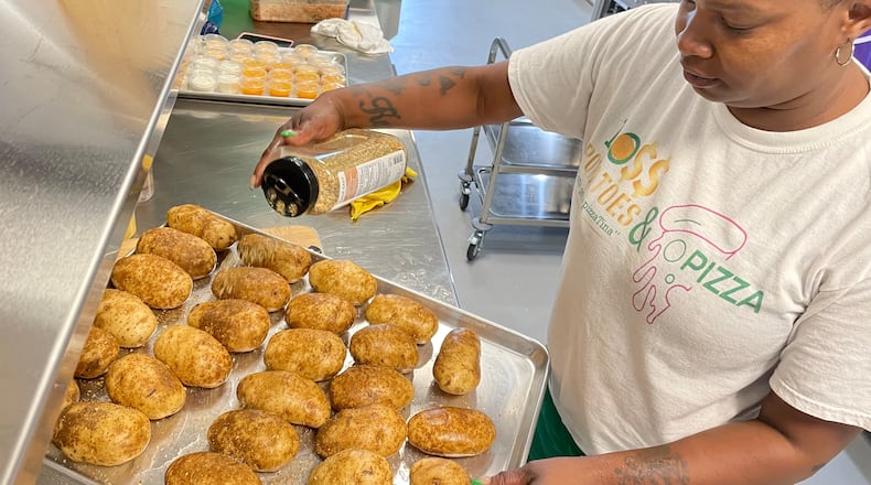 Dayton native Martina Scott, owner of Boss Potatoes, has quadrupled her customer base since she started cooking from her home almost four years ago. On Wednesday, Aug. 7 she started her first day as a member of 6888 Kitchen Incubator at the Dayton Arcade. NATALIE JONES/STAFF