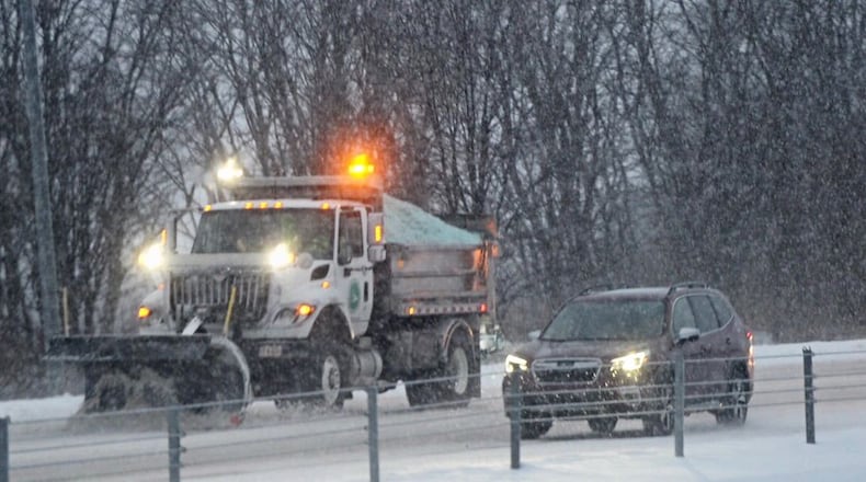 Ohio Department of Transportation trucks plow snow on I-675 near Wilmington Pike Tuesday morning, February 16, 2021.