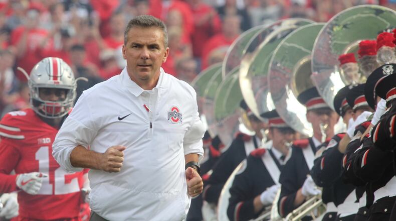 Ohio State’s Urban Meyer runs onto the field before a game against Northwestern on Saturday, Oct. 29, 2016, at Ohio Stadium in Columbus. David Jablonski/Staff