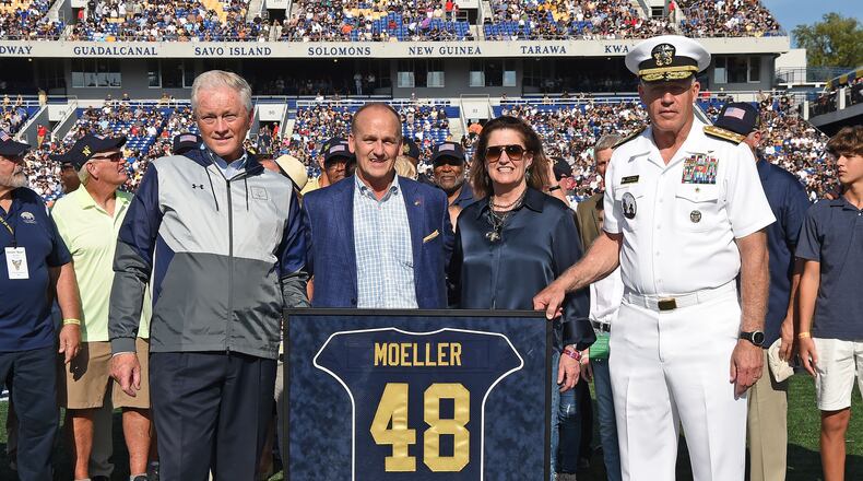 Fairmont West graduate Chet Moeller's No. 48 jersey was retired by the Navy football team at halftime of Satudray's game vs. Central Florida as he was recognized as the greatest defensive player in program history. Pictured from left: Naval Academy Director of Athletics Chet Gladchuk, Chet and his wife Jenny and Superintendent Admiral Sean Buck, USN. Photo courtesy of Navy Athletics