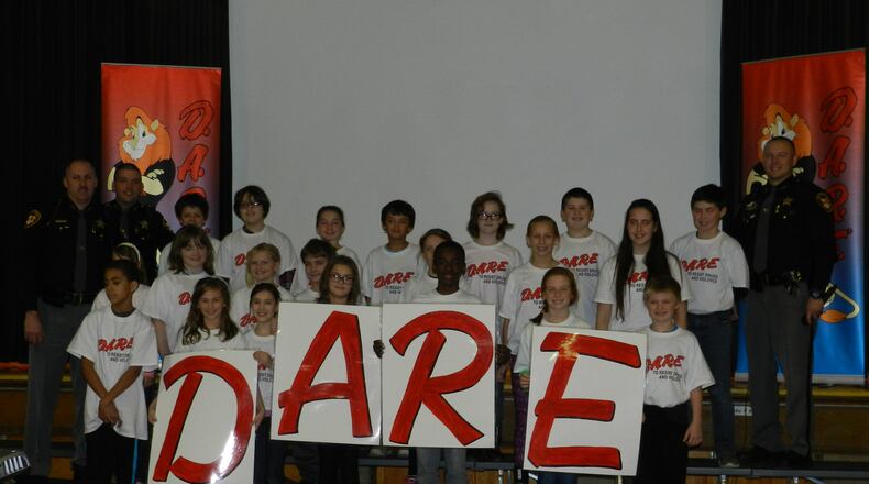 The Beavercreek Police Department wants to apply for a grant to help finance its DARE program for 2017-18. The DARE program is used in school districts nearly everywhere. In this photo fifth-grade students in the Clark-Shawnee Local School District display a DARE program related project. CONTRIBUTED