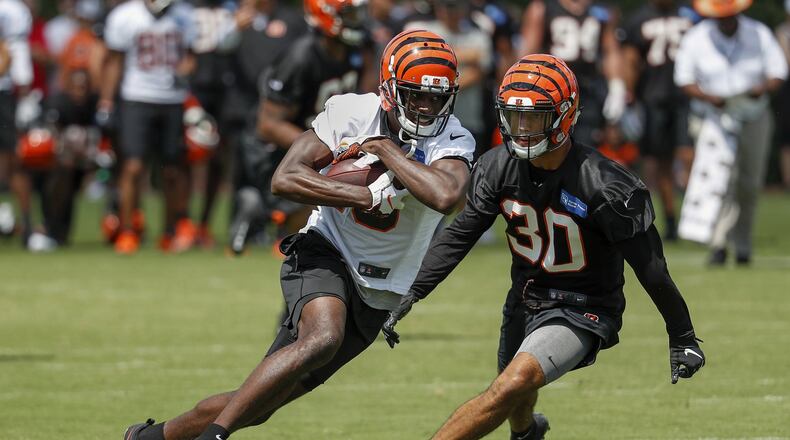 Cincinnati Bengals wide receiver A.J. Green, left, runs a play during NFL football practice, Friday, July 27, 2018, in Cincinnati. (AP Photo/John Minchillo)