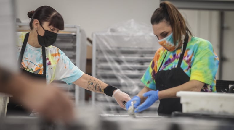 Angela Abnett, left and Laura Joslin make Thanksgiving meal at Daybreak in partnership with Miami Valley Meals. The frozen dinners will be distributed from 9 a.m. to noon Wednesday, Nov. 25, 2020, at UD Arena and Trotwood-Madison High School.