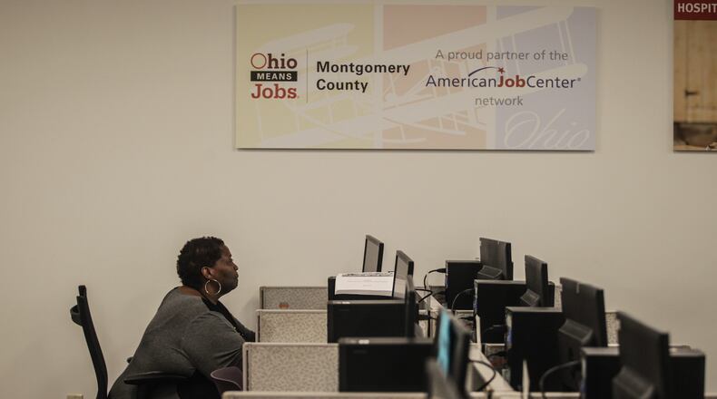 Dayton Job Center employee Renita Washington was seen working at a computer at the center recently. JIM NOELKER/STAFF