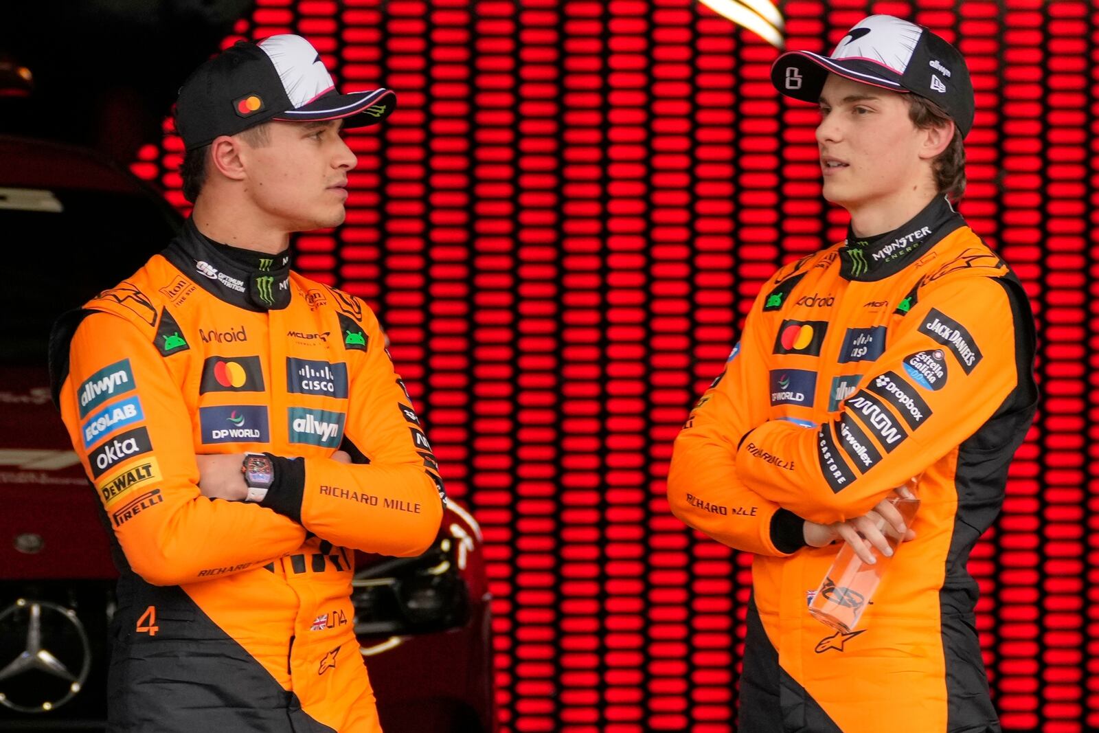 McLaren drivers Lando Norris of Britain, left, and Oscar Piastri of Australia, right, talk after qualifying session for the Japanese Formula One Grand Prix at the Suzuka Circuit in Suzuka, central Japan, Saturday, April 5, 2025. (AP Photo/Shuji Kajiyama)