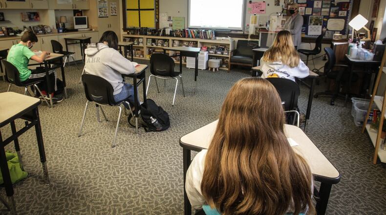 Oakwood Junior. High students listen to to english teacher, Ann  Whitehair's lecture Monday Nov. 30, 2020.  The school has been has been using the same plan all year where students attend half-days, five days a week.