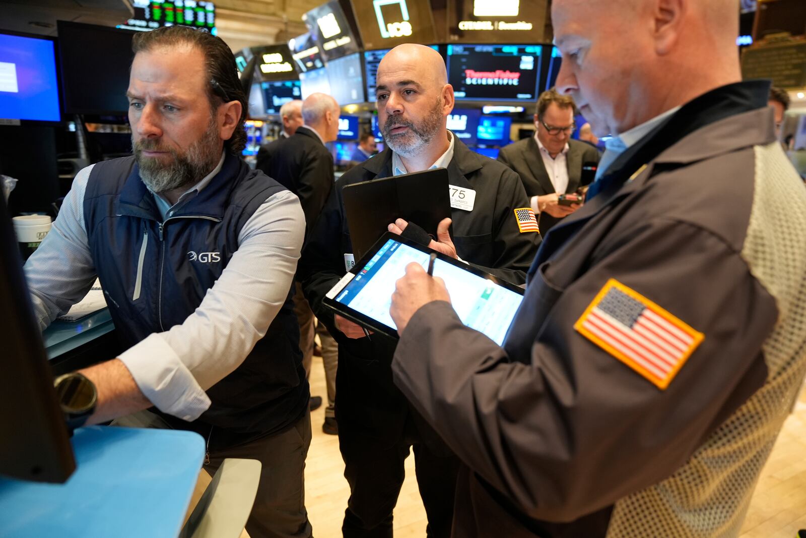 Traders work on the floor at the New York Stock Exchange in New York, Tuesday, April 8, 2025. (AP Photo/Seth Wenig)