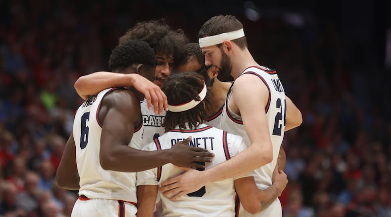 Dayton players huddle during a game against Loyola Chicago on Saturday, Jan. 18, 2025, at UD Arena. David Jablonski/Staff