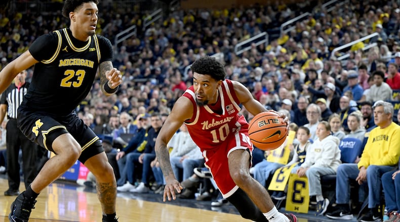 Nebraska guard Jamarques Lawrence (10) drives the baseline against Michigan forward Yaxel Lendeborg (23) in the first half of an NCAA college basketball game in Ann Arbor, Mich., Tuesday, Jan. 27, 2026. (AP Photo/Lon Horwedel)