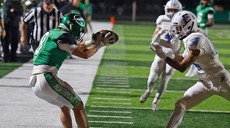 Northmont's Brady Lupton keeps his feet inbounds as he catches a pass under pressure from Fairborn's Andrew Wilson Friday, Oct. 27, 2023. BILL LACKEY/STAFF