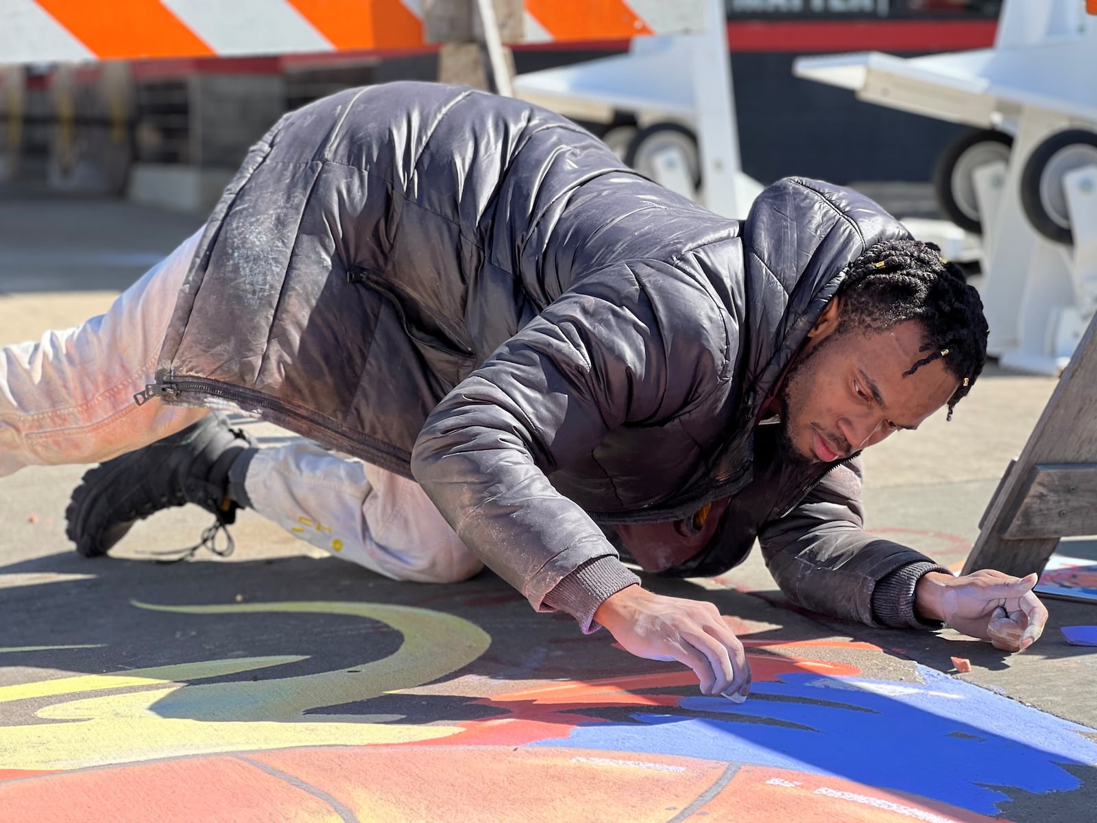 Local artist Ben “Boy Blue” Baugham puts the finishing touches on a chalk drawing during the Big Hoopla Family Festival in The Oregon District on Sunday, Mar. 13, 2022 TOM GILLIAM / CONTRIBUTING PHOTOGRAPHER