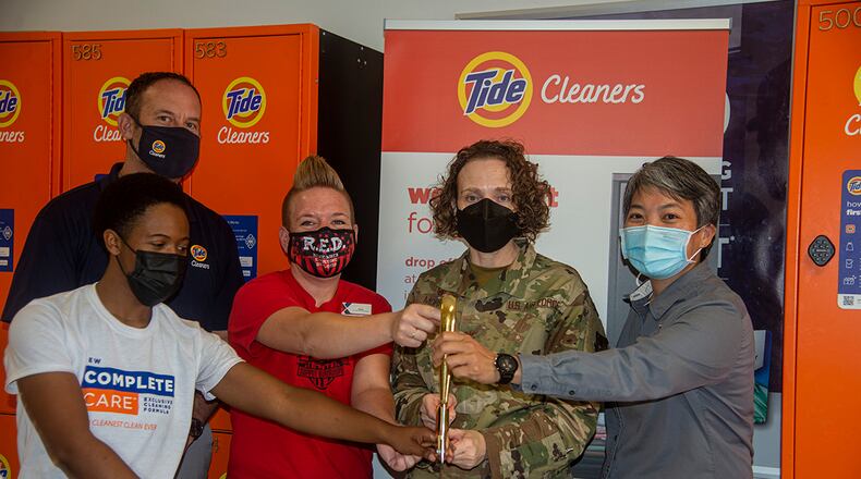 From right: Keola Chan, Base Exchange general manager; Col. Sirena Morris, 88th Mission Support Group commander; Sara Bateman, Base Exchange services business manager; Shaneice Neal, Tide driver; and Michael Aschbrenner, senior director of corporate operations for Tide Cleaners, cut the ribbon Sept. 17 to open “Tide Lockers” at Wright-Patterson Air Force Base. U.S. AIR FORCE PHOTO/AIRMAN 1ST CLASS JACK GARDNER