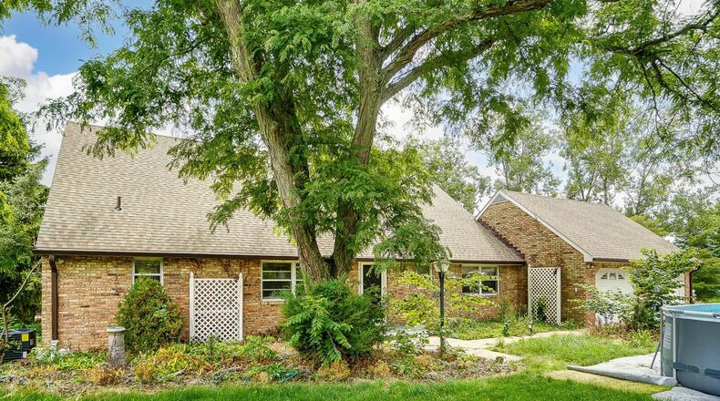 The front of the home has a two-car attached garage, an oversized asphalt driveway and an above-ground pool. Contributed photos