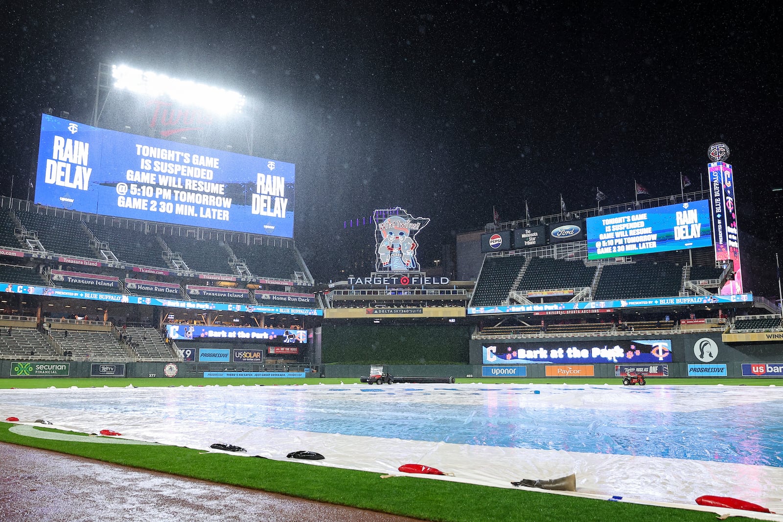 The scoreboard announces the suspension of a baseball game during the fourth inning between the Minnesota Twins and the Cleveland Guardians, Monday, May 19, 2025, in Minneapolis. (AP Photo/Matt Krohn)