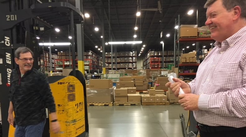 James Dromey, Jr., right, American Honda Motor Co. senior manager, procurement and logistics, shares a laugh with a worker at the company’s Midwest Consolidation Center in Troy. THOMAS GNAU/STAFF