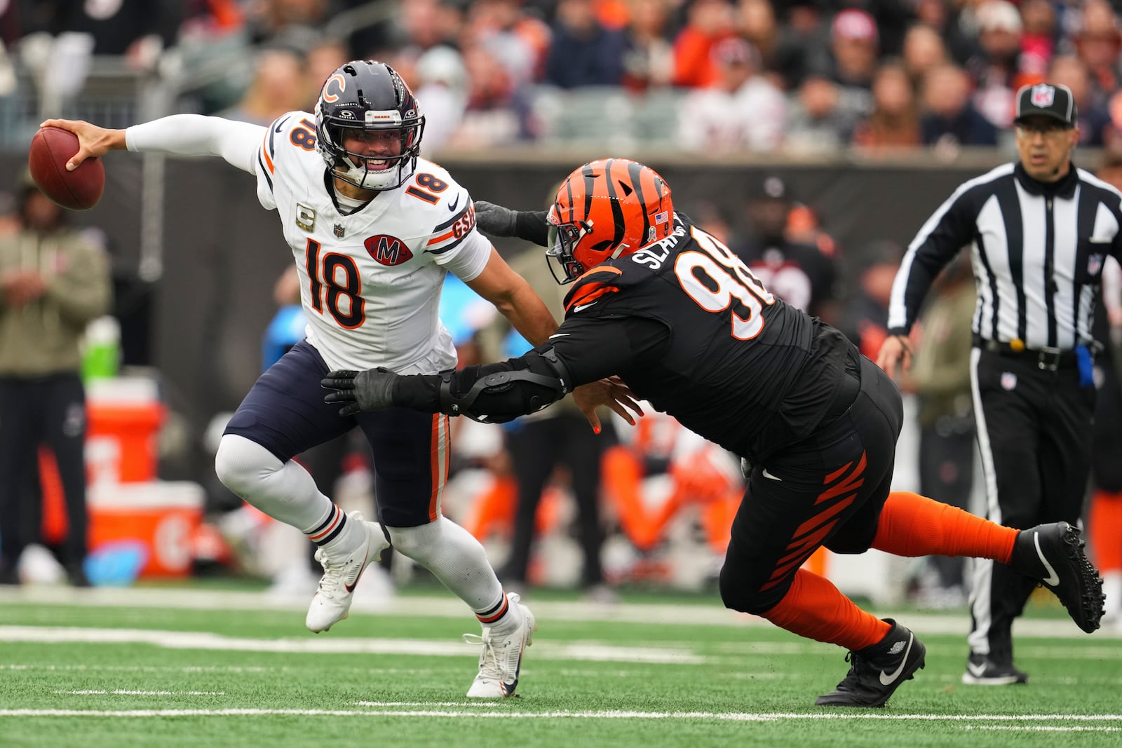 Cincinnati Bengals defensive tackle T.J. Slaton Jr. (98) pressures Chicago Bears quarterback Caleb Williams (18) during the first half of an NFL football game, Sunday, Nov. 2, 2025, in Cincinnati. (AP Photo/Jeff Dean)