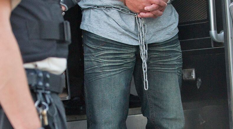 An illegal immigrant from El Salvador steps off a transport bus from the Florence, Ariz., prison, prior to being boarded on an MD-80 aircraft at Phoenix-Mesa Gateway Airport in Mesa, Ariz. Tuesday, June 26, 2012. Immigration and Customs Enforcement (ICE) operate four to five repatriation flights weekly to El Salvador, Guatemala and Nicaragua. Shackled violent offenders, minors and women are separated on the flight and are turned over to El Salvador's immigration officers upon arrival. (AP Photo/Matt York)