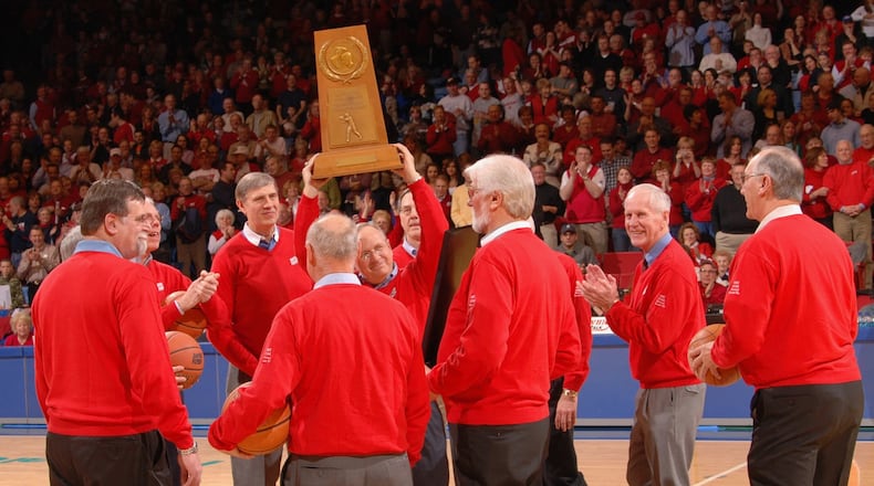Bobby Joe Hooper, center, hoists the Dayton Flyers' 1967 NCAA runner-up trophy during a 40th reunion celebration at UD Arena in 2007. Photo by Timothy Boone