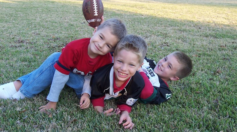 From left, Adam, Andrew and Alec Trautman in 2003. CONTRIBUTED