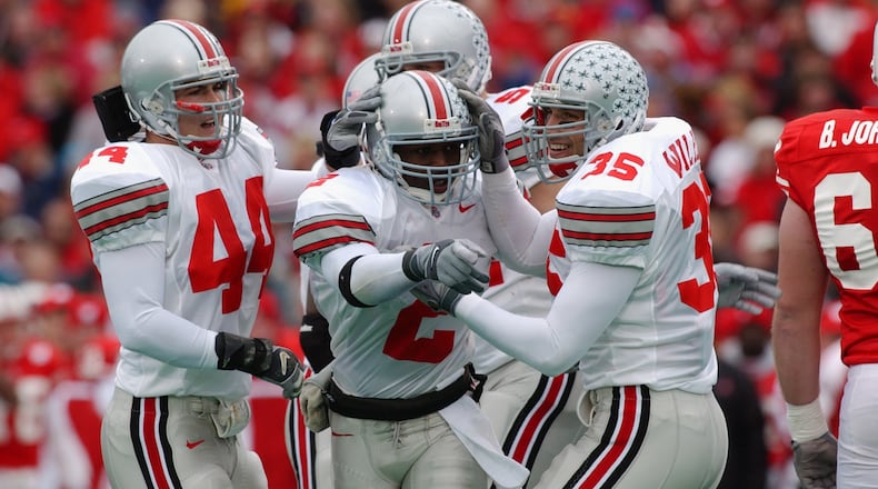 MADISON, WI - OCTOBER 19: Safety Mike Doss #2 of Ohio State celebrates a fumble recovery with linebacker teammates Matt Wilhelm #35 and Robert Reynolds #44 during the NCAA football game against Wisconsin at Camp Randall Stadium in Madison, Wisconsin on October 19, 2002. The Ohio State Buckeyes defeated the Wisconsin Badgers 14 - 19. (Photo by Jonathan Daniel /Getty Images)