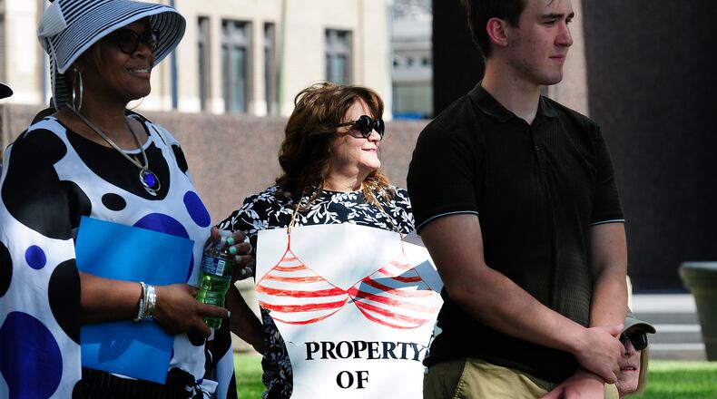 Ann Marie, proudly wears her 'Property of Me' sign Monday, June 24, 2024 at the Federal Building in Dayton while protesting anti-abortion efforts across the country and the Supreme Court's Dobbs decision two years ago. MARSHALL GORBY\STAFF