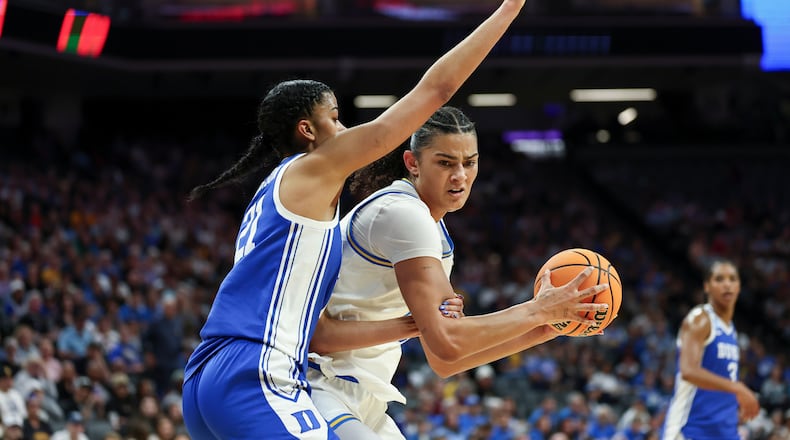UCLA center Lauren Betts, right, battles in the paint with Duke center Arianna Roberson (21) during the first half in the Elite Eight of the NCAA college basketball tournament, Sunday, March 29, 2026, in Sacramento, Calif. (AP Photo/Sara Nevis)