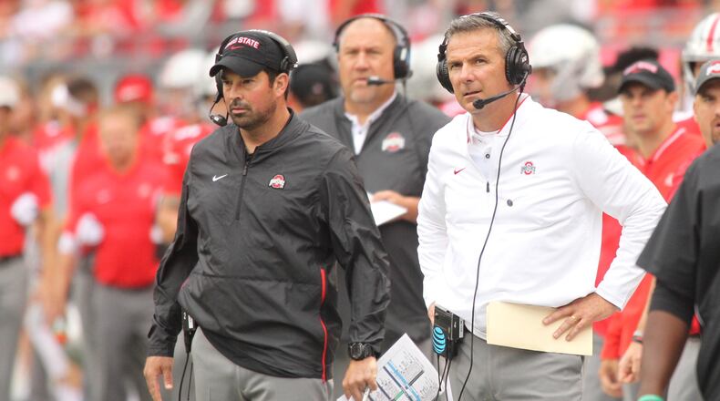 Ohio State’s Ryan Day, left, and Urban Meyer watch the action during a game against Tulane on Saturday, Sept. 22, 2018, at Ohio Stadium in Columbus. David Jablonski/Staff
