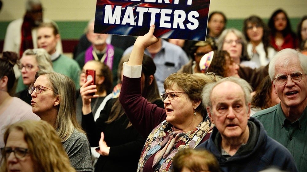 An audience member holds up a sign at a faith event supporting Haitians at St. John Missionary Baptist Church Monday, Feb. 2, 2026. Contributed photo Buck Creek Photography